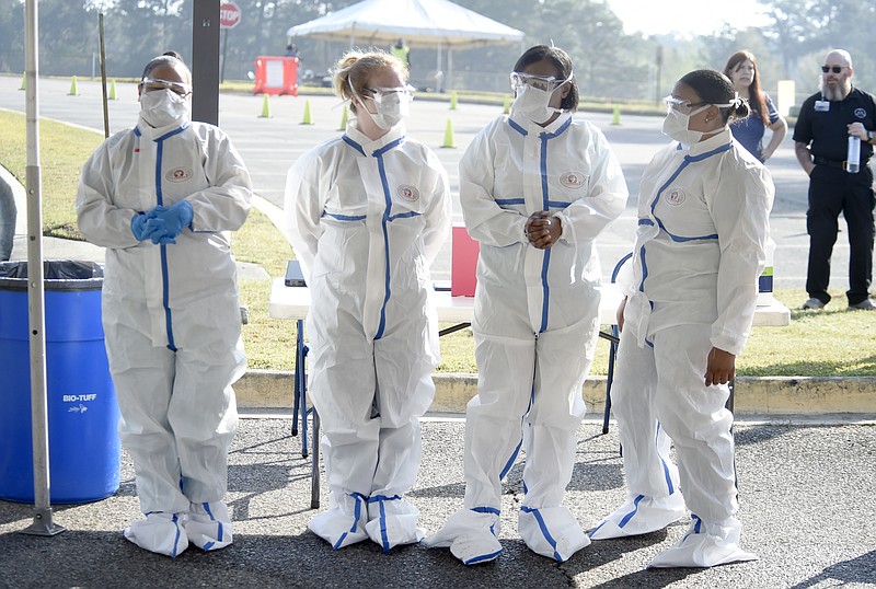 The Associated Press / Registered nurses and patient care technicians wait for their next patient to drive up to be tested for the coronavirus in Augusta, Georgia, last week.