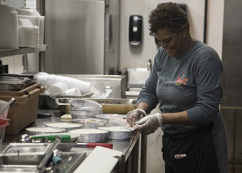 Staff photo by Troy Stolt / Back of house worker Wanda White prepares an order for a drive through costumer at Bones Smokehouse, located at 7601 East Brainerd road, on Monday, March 23, 2020 in Chattanooga, Tenn. Many restaurants in Hamilton County have shut down in an effort to halt the spread of coronavirus, or have switched to carry out only for the time being. 