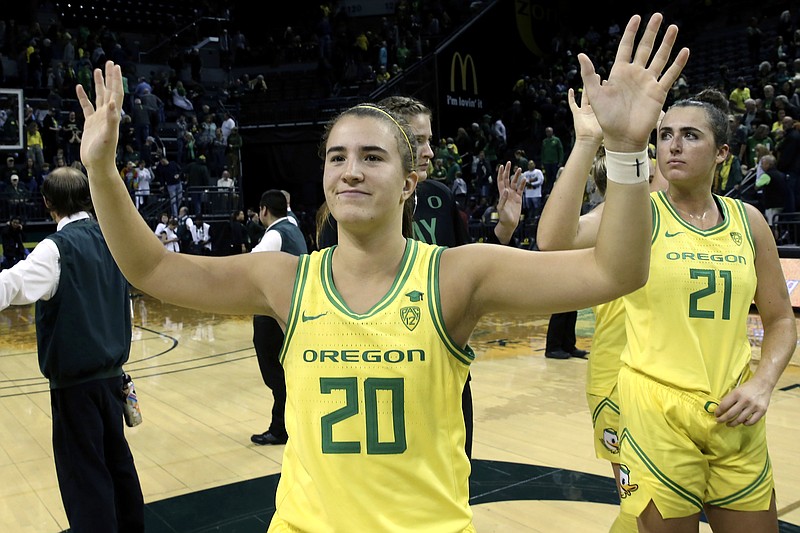 FILE - In this Nov. 16, 2019, file photo, Oregon's Sabrina Ionescu acknowledges the crowd with teammates after an NCAA college basketball game against Texas Southern in Eugene, Ore. Ionescu capped off a unprecedented college career by entering an exclusive club. Oregon's star guard was a unanimous choice Monday, March 23, 2020, as The Associated Press women's basketball player of the year. She was only the second player ever to the lone recipient of votes, joining Breanna Stewart, since the award was first given in 1995. (AP Photo/Chris Pietsch, FIle)