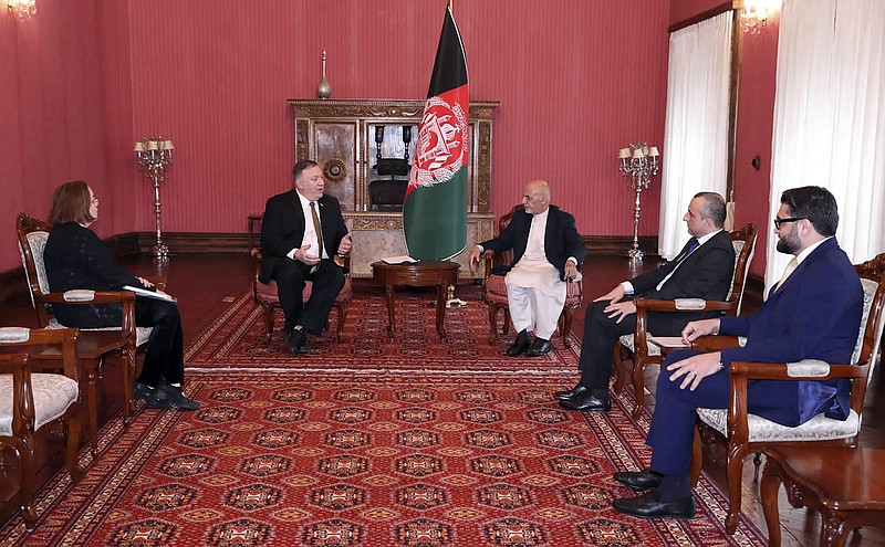 U.S. Secretary of State Mike Pompeo, center left, meets with Afghan President Ashraf Ghani, center right, at the Presidential Palace in Kabul, Afghanistan, Monday, March 23, 2020. Pompeo was in Kabul on an urgent visit Monday to try to move forward a U.S. peace deal signed last month with the Taliban, a trip that comes despite the coronavirus pandemic, at a time when world leaders and statesmen are curtailing official travel. (Afghan Presidential Palace via AP)