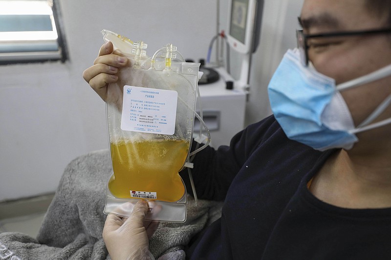 FILE - In this Feb. 18, 2020, file photo, Dr. Zhou Min, a recovered COVID-19 patient who has passed his 14-day quarantine, donates plasma in the city's blood center in Wuhan in central China's Hubei province. Plasma from recovered COVID-19 patients contains antibodies that may help reduce the viral load in patients that are fighting the disease. (Chinatopix via AP, File)


