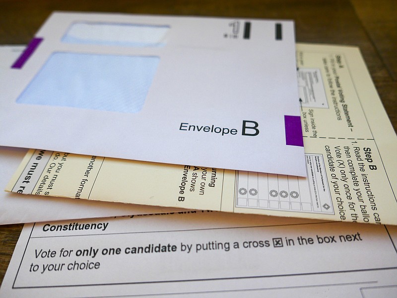 UK General Election postal vote ballot papers. The paperwork includes a return envelope, instructions on how to complete the postal vote and a ballot paper with constituency candidate names and details on how to vote for just one candidate by putting a cross in the box next to the voters choice. vote ballot tile voter tile / Getty Images