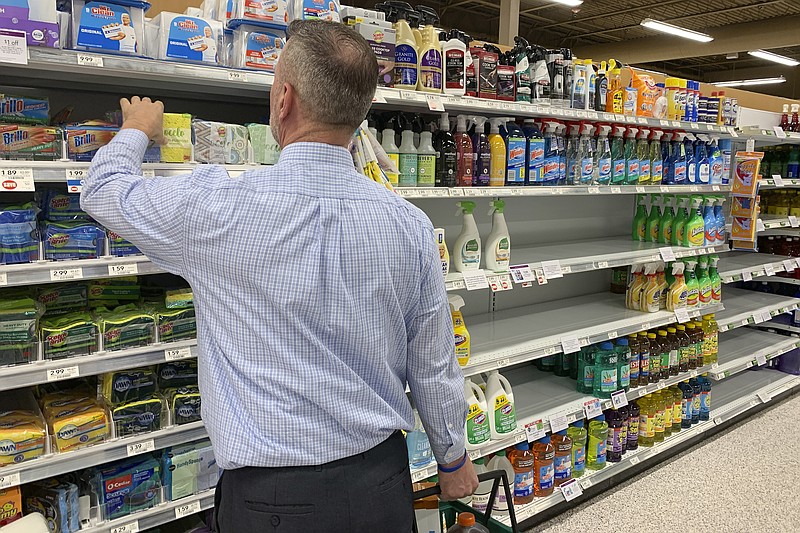 A customer looks for scrubbing pads near empty shelves of cleaning supplies at a Publix Supermarket amid concern over the COVID-19 virus on Monday, March 9, 2020, in Pembroke Pines, Fla. (AP Photo/Brynn Anderson)



