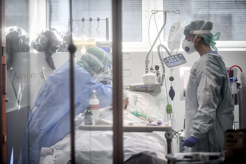 FILE - In this Thursday, March 19, 2020, file photo, medical personnel work in the intensive care unit of a hospital in Brescia, Italy. World War II references are now heard daily, not because another momentous 75th anniversary, Victory in Europe Day approaches in May but because of the coronavirus. (Claudio Furlan/LaPresse via AP, File)


