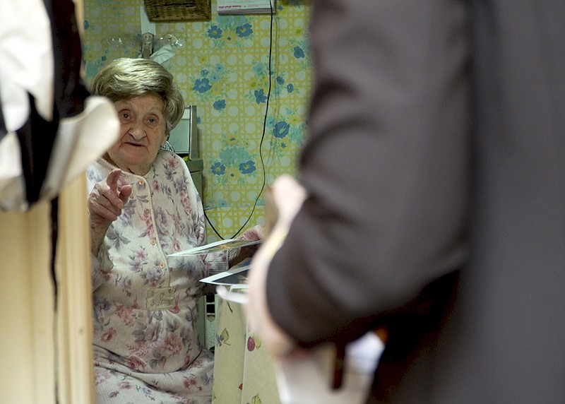 In this March 19, 2020 photo, Holocaust survivor Hannah Nudel talks to volunteer Freida Rothman, who is delivering meals to survivors isolated in their homes because of coronavirus concerns, in Brooklyn, New York. (AP Photo/Jessie Wardarski)

