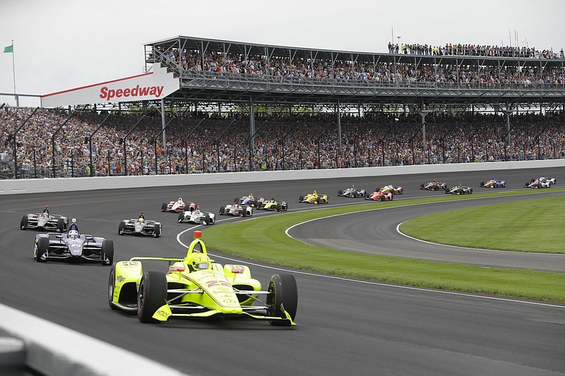 AP photo by Darron Cummings / Simon Pagenaud leads the field through the first turn after the start of the 2019 Indianapolis 500 on May 26 at Indianapolis Motor Speedway. This year's Indy 500 was scheduled for May 24 but has been postponed until Aug. 23 because of the coronavirus pandemic, meaning the iconic race won't be held on Memorial Day weekend for the first time since 1946.