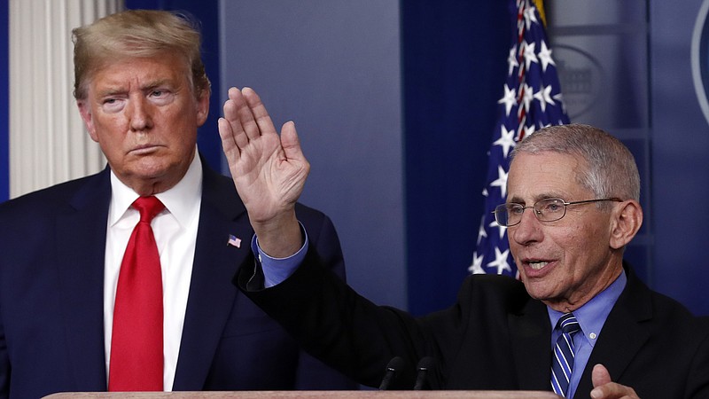 Photo by Alex Brandon of The Associated Press / President Donald Trump listens as Dr. Anthony Fauci, director of the National Institute of Allergy and Infectious Diseases, speaks about the coronavirus in the James Brady Briefing Room on March 24, 2020, in Washington.