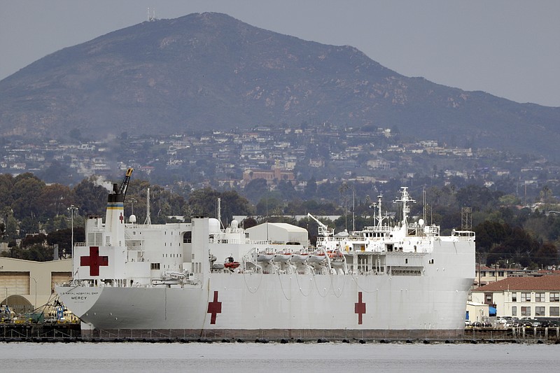 FILE - In this Wednesday, March 18, 2020, file photo, The USNS Mercy, a Navy hospital ship is seen docked at Naval Base San Diego in San Diego, Calif. To help combat an expected shortage of hospital beds as the virus spreads, the U.S. Naval hospital ship Mercy departed San Diego on Monday, March 23, bound for Los Angeles to treat non-coronavirus patients. The 1,000-bed USNS Mercy is expected to arrive in less than a week and begin accepting patients within a day of arrival, Capt. John R. Rotruck said. (AP Photo/Gregory Bull, File)


