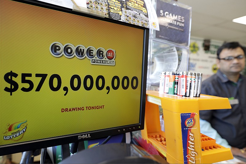 FILE - In this Jan. 6, 2018 file photo, a Powerball lottery sign displays the lottery prizes at a convenience store in Chicago. Lottery jackpots are going to shrink as the coronavirus pandemic tamps down lottery sales. The group that oversees the Powerball game announced Wednesday, March 25, 2020, that it would cut minimum jackpots in half, from $40 million to $20 million, after there is a winner of the current big prize. The jackpot also could grow more slowly, with minimum increases of $2 million instead of the normal $10 million after each twice-weekly drawing. (AP Photo/Nam Y. Huh File)


