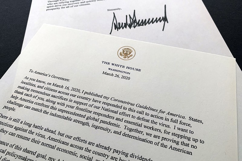A letter from President Donald Trump to the nation's governors is photographed Thursday, March 26, 2020. Trump says that federal officials are developing guidelines to rate counties by risk of virus spread and that he wants to begin easing nationwide guidelines meant to stem the coronavirus outbreak. In the letter, Trump says the new guidelines are meant to enable state and local leaders to make "decisions about maintaining, increasing, or relaxing social distancing and other measures they have put in place." (AP Photo/Jon Elswick)


