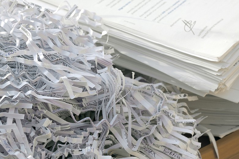 Confidential documents being shredded. / Getty Images/iStock/DeepBlueProductions