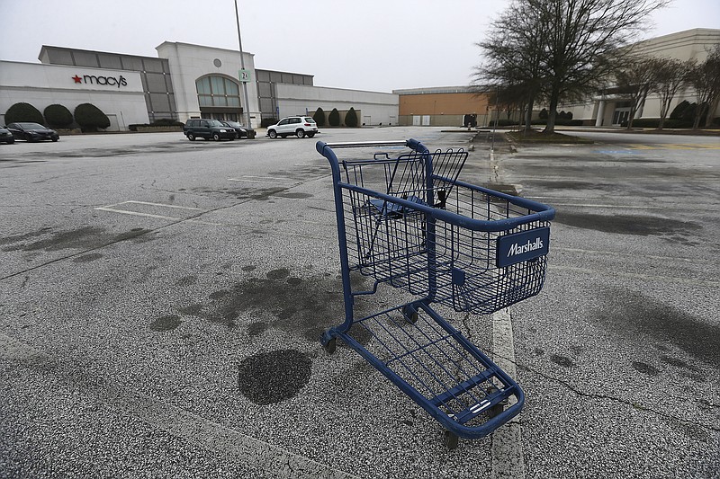 Photo by Curtis Compton of AJC.com / A few vehicles and an abandoned shopping cart are seen outside one of the entrances to Macy's at Stonecrest Mall reflecting the economic slowdown during the coronavirus on Tuesday, March 17, 2020, in Stonecrest.