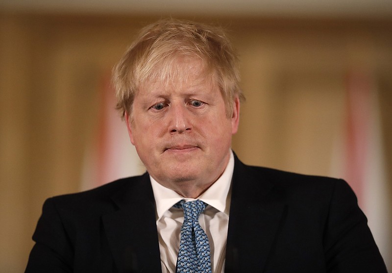 FILE - In this Tuesday, March 17, 2020 file photo British Prime Minister Boris Johnson gives a press conference about the ongoing situation with the COVID-19 coronavirus outbreak inside 10 Downing Street in London. British Prime Minister Boris Johnson has tested positive for the new coronavirus. Johnson's office said Friday March 27, 2020 that he was tested after showing mild symptoms, Downing St. says Johnson is self-isolating and continuing to lead the country's response to COVID-19. (AP Photo/Matt Dunham, Pool)


