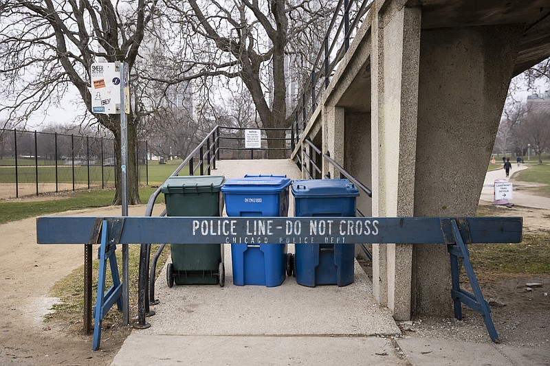 Chicago police block access to the Lake Shore Drive pedestrian bridge leading to the Lakefront Trail at North Avenue Beach as the city closes the area to pedestrians amid fears of the coronavirus pandemic, Thursday morning, March 26, 2020. (Ashlee Rezin Garcia/Chicago Sun-Times via AP)


