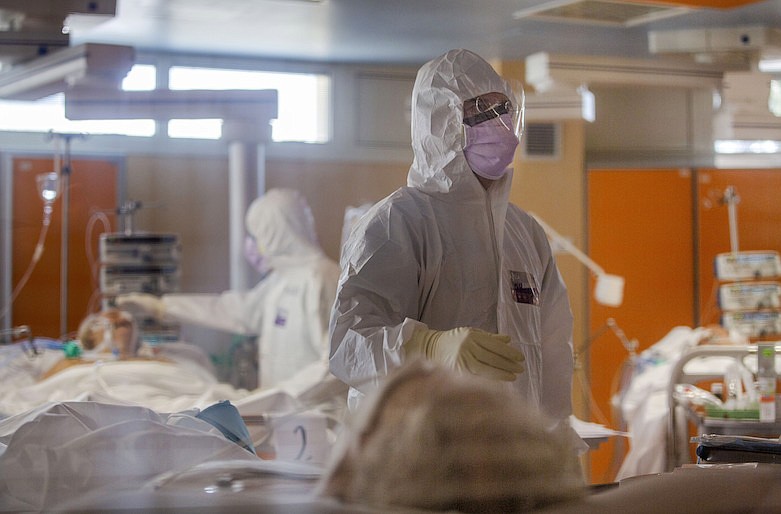 Medical staff at the intensive care unit of the Casalpalocco COVID-19 Clinic on the outskirts of Rome tend to patients, Wednesday, March 25, 2020. (AP Photo/Domenico Stinellis)
