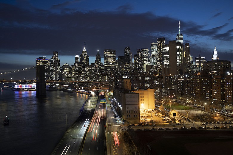 Cars head along FDR Drive next to the Manhattan skyline, Thursday, March 26, 2020, during the coronavirus outbreak in New York. Because of Gov. Andrew Cuomo's "stay-at-home" orders for all but essential workers, the streets and highways are quieter than normal. (AP Photo/Mark Lennihan)