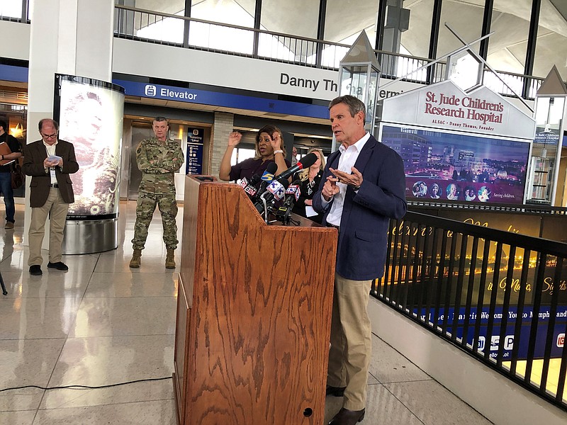 Tennessee Gov. Bill Lee (right, at podium) speaks to reporters at Memphis International Airport about the state's response to the new coronavirus on Friday, March 27, 2020, in Memphis, Tenn. (AP Photo/Adrian Sainz).


