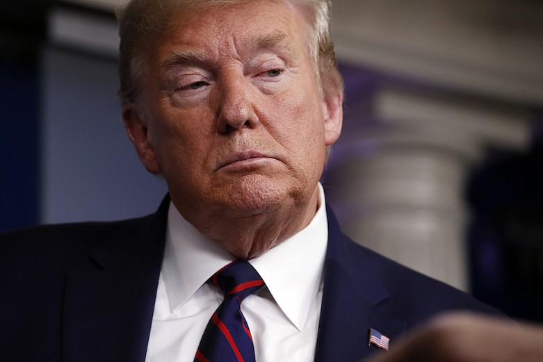 President Donald Trump listens to a question as he speaks about the coronavirus in the James Brady Press Briefing Room, Friday, March 27, 2020, in Washington. (AP Photo/Alex Brandon)