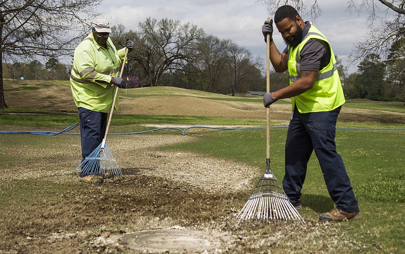 Staff photo by Troy Stolt / City of Chattanooga Wastewater crew workers Derrick Grimes, right, and James Murphy clear solidified human waste from around a backed up man hole at Brainerd Golf Course on Saturday, March 28, 2020 in Chattanooga, Tenn. Coronavirus has lead to many Chattanoogans spending more time at home and due to social distancing and businesses being shut down, and as a result the City is facing disproportionate amount of sewer lines getting clogged, the flushing of disinfecting wipes down the toilet has been a leading cause of back ups.