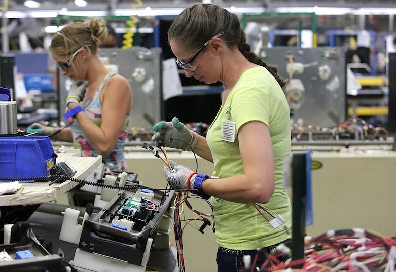 Maurine Carter works on the wiring of a stove Friday, Sept. 20, 2019, at the GE Appliances' Roper Plant in LaFayette, Georgia. / Staff file photo