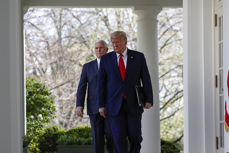 President Donald Trump and Vice President Mike Pence arrive to speak about the coronavirus in the Rose Garden of the White House, Monday, March 30, 2020, in Washington. (AP Photo/Alex Brandon)


