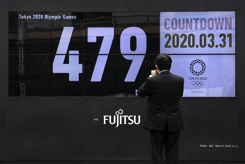 AP photo by Jae C. Hong / A man takes pictures of a countdown display for the Tokyo 2020 Olympics and Paralympics on Tuesday in Tokyo. The countdown clock is ticking again for the Tokyo Olympics, which have been rescheduled for July 23 to Aug. 8, 2021, meaning there are 479 days to go.