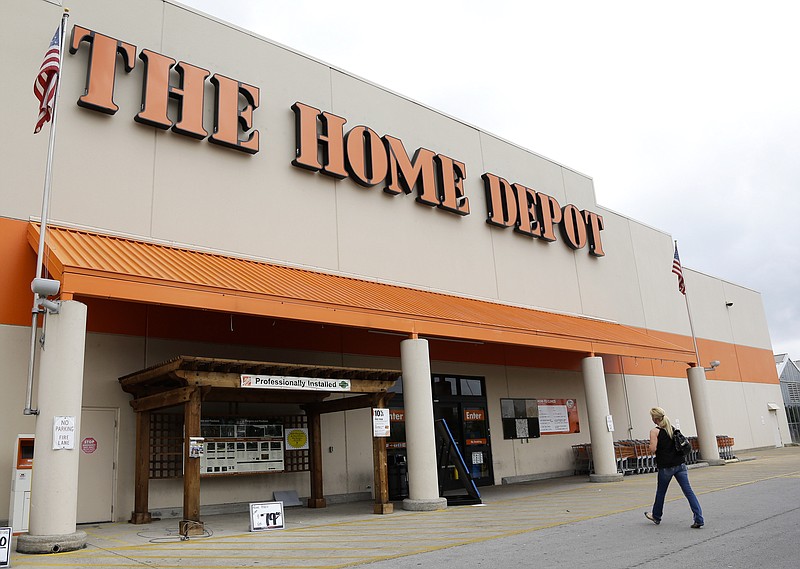 A Home Depot sign is shown on Tuesday, Aug. 14, 2012, in Nashville, Tenn. Home Depot is limiting the number of customers in its stores, curtailing opening hours, adding paid leave for employees and ending sales of protective masks. / Photo by Mark Humphrey