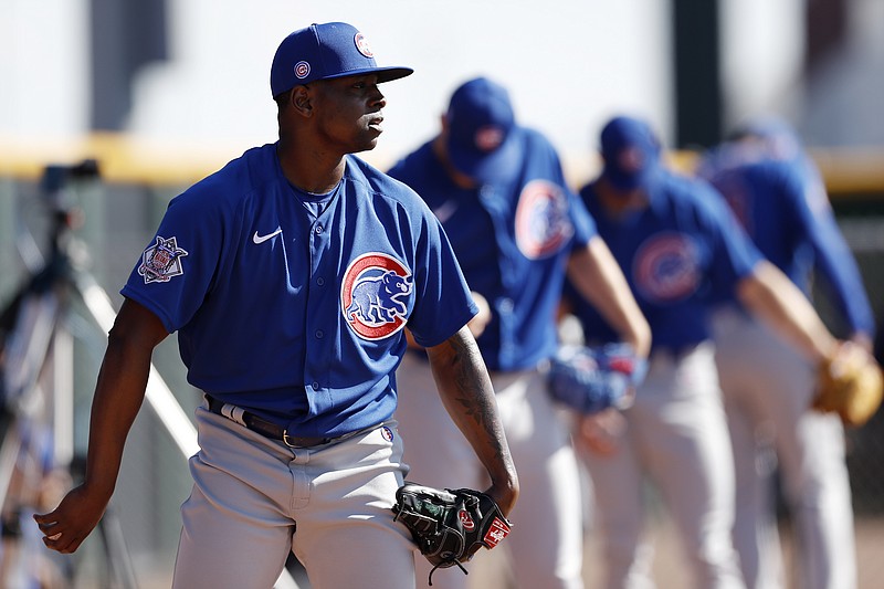 AP photo by Gregory Bull / Chicago Cubs right-hander Jharel Cotton, left, throws alongside other pitchers during a spring training workout on Feb. 12 in Mesa, Ariz.