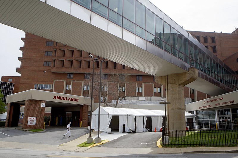 Staff photo by C.B. Schmelter / Tents are seen being set up outside of the adult emergency room at Erlanger on Monday, March 30, 2020 in Chattanooga, Tenn.