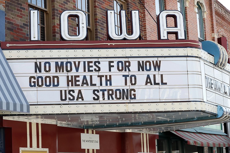 The marquee for the Iowa Theater, closed in response to the coronavirus outbreak, is seen on John Wayne Drive, Wednesday, April 1, 2020, in Winterset, Iowa. The new coronavirus causes mild or moderate symptoms for most people, but for some, especially older adults and people with existing health problems, it can cause more severe illness or death. (AP Photo/Charlie Neibergall)