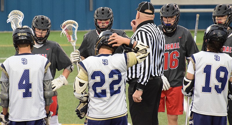 Contributed photo by Cindy Little / Signal Mountain and Soddy-Daisy lacrosse players meet at midfield ahead of their March 4 game at Boyd Buchanan School. Signal Mountain won 12-10 as part of its 4-0 start to this season, which is on hiatus due to the COVID-19 pandemic.