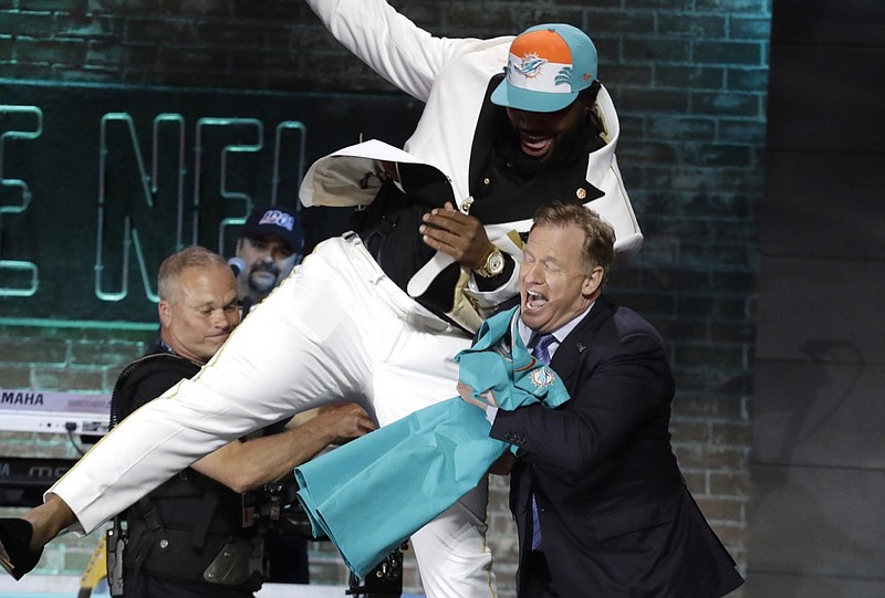 AP photo by Steve Helber / Clemson defensive tackle Christian Wilkins playfully bumps into NFL commissioner Roger Goodell after the Miami Dolphins drafted Wilkins in the first round on April 25, 2019, in Nashville.