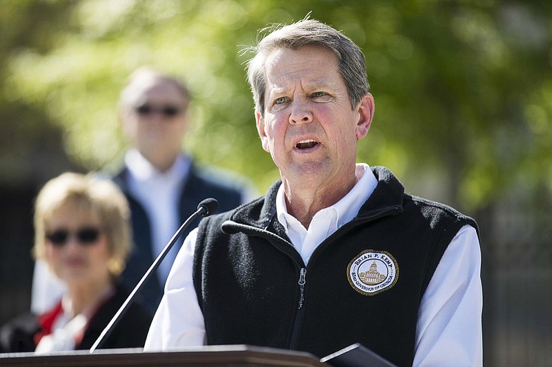 Georgia Gov. Brian Kemp speaks during a news conference at Liberty Plaza across the street from the Georgia state Capitol building in downtown Atlanta, Wednesday, April 1, 2020. Kemp says he will issue a statewide shelter-in-place order to prevent spread of the coronavirus and shut down public schools for the rest of the year. (Alyssa Pointer/Atlanta Journal-Constitution via AP)