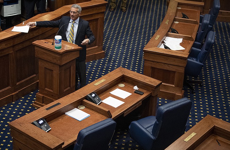 Senator Del Marsh presents a resolution, in a nearly empty Senate Chamber with barely a quorum present, allowing an adjournment until April 28, in Montgomery, Ala., on Tuesday March 31, 2020. (Mickey Welsh/The Montgomery Advertiser via AP)