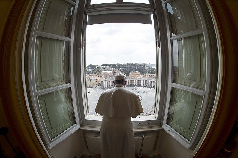 Photo by Vatican News via The Associated Press / Pope Francis delivers his blessing from the window of his studio overlooking an empty St. Peter's Square due to restrictions to contain the COVID-19 virus, at the Vatican on Sunday, March 29, 2020.