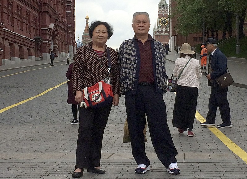 This May 13, 2019 photo provided by Liu Dong'e shows her and her husband, Wu Chuanyong, while visiting Moscow. Wu Chuanyong had been enjoying a peaceful retirement in the central Chinese city of Wuhan. The 68-year-old family patriarch began each morning with a stroll through the park and ended the day watching television dramas. Then the coronavirus hit, quickly spreading in Wuhan and around the world. (Courtesy Liu Dong'e via AP)


