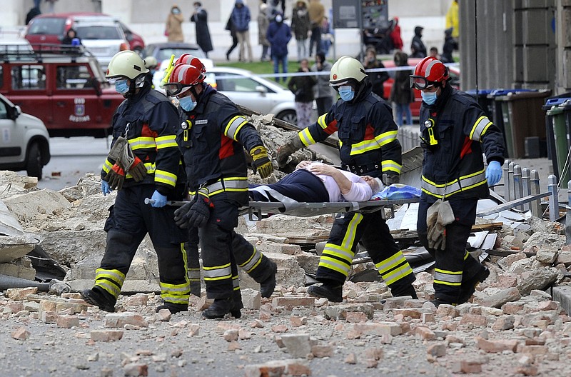 FILE - In this March 22, 2020, file photo, firefighters carry a person on a stretcher after a strong earthquake in Zagreb, Croatia. The virus outbreak is compromising the ability of nations to prepare for natural disasters and deal with the aftermath. Every year, the world contends with devastating typhoons, wildfires, tsunamis and earthquakes. (AP Photo/File)


