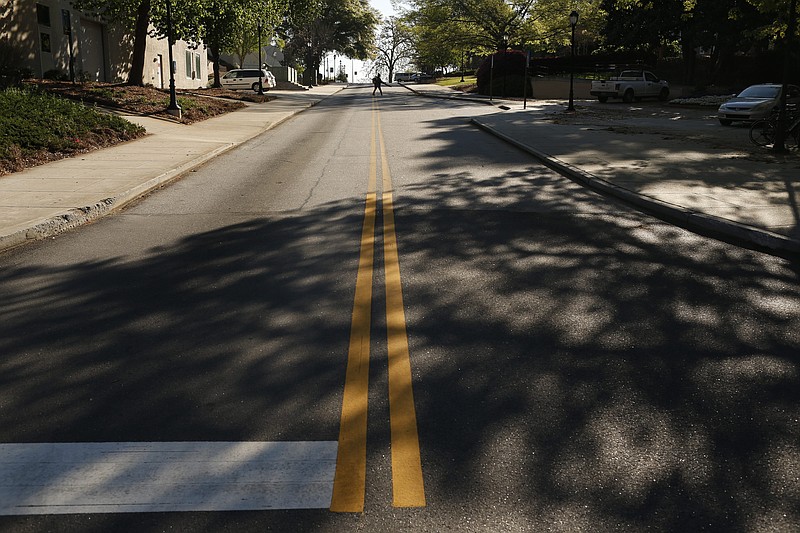 A lone landscaper blows off leaves in the middle of Hooper Street on the empty campus of the University of Georgia, in Athens, Ga, on Thursday, April 2, 2020. UGA moved all classes online for the remainder of spring and summer semesters as well as canceling spring commencement In order to prevent the spread of COVID-19. (Joshua L. Jones/Athens Banner-Herald via AP)


