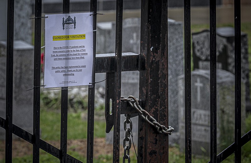 A sign on the locked gates of Canarsie Cemetery explains it will remain closed for visitations, as part of efforts to limit the spread of the coronavirus, Friday April 3, 2020, in the Brooklyn borough of New York. (AP Photo/Bebeto Matthews)


