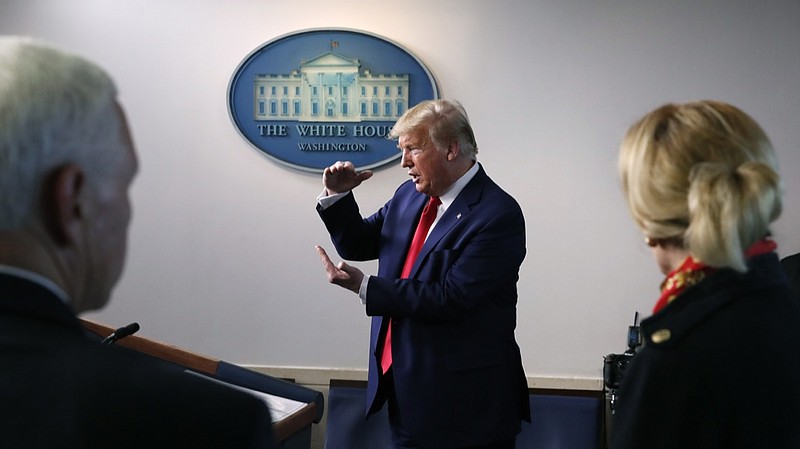 FILE - In this March 31, 2020, file photo President Donald Trump speaks about the coronavirus in the James Brady Press Briefing Room of the White House in Washington, as Vice President Mike Pence and Dr. Deborah Birx, White House coronavirus response coordinator, listen. Trump in recent days has grumbled that American companies such as 3M and GM are not doing enough to provide American medical workers and first responders with vital equipment they need. (AP Photo/Alex Brandon, File)