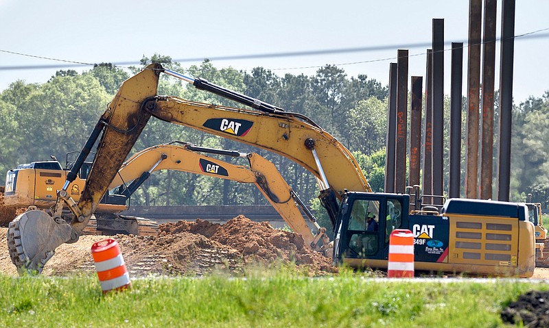 Staff Photo by Robin Rudd / Two pieces of heavy equipment move earth at the intersection of Interstates 75 and 24 on April 6, 2020.