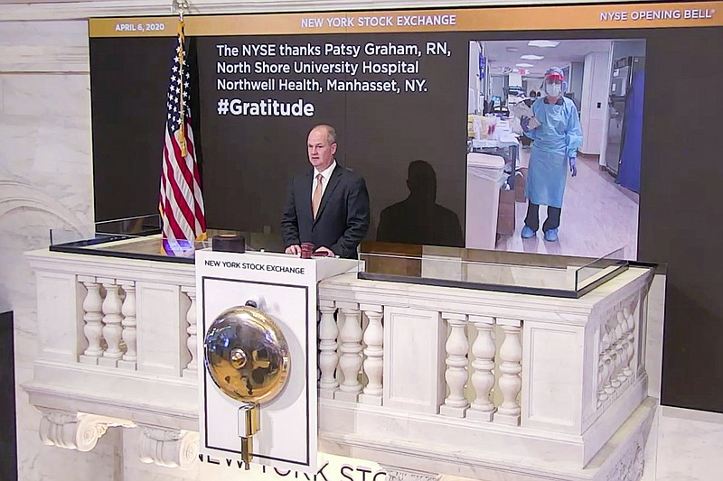 In this photo taken from video provided by the New York Stock Exchange, Chief Security Officer Kevin Fitzgibbons rings the opening bell at the NYSE, Monday, April 6, 2020, recognizing Patsy Graham, a registered nurse at North Shore University Hospital Northwell Health, in Manhasset, NY. Stocks jumped in markets around the world Monday after some of the hardest-hit areas offered sparks of hope that the worst of the coronavirus outbreak may be on the horizon. (New York Stock Exchange via AP)