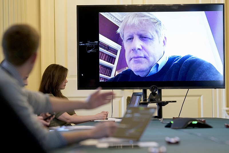 FILE - In this Saturday, March 28, 2020 handout photo provided by Number 10 Downing Street, Britain's Prime Minister Boris Johnson chairs the morning Covid-19 Meeting remotely after self isolating after testing positive for the coronavirus, at 10 Downing Street, London. British Prime Minister Boris Johnson has been admitted to a hospital with the coronavirus. Johnson's office says he is being admitted for tests because he still has symptoms 10 days after testing positive for the virus. (Andrew Parsons/10 Downing Street via AP, File)

