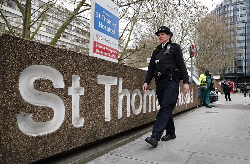 A police officer patrols outside a hospital where it is believed but not confirmed that Britain's Prime Minister Boris Johnson is undergoing tests after suffering from coronavirus symptoms, in London, Monday, April 6, 2020. British Prime Minister Boris Johnson has been admitted to a hospital with the coronavirus. Johnson's office says he is being admitted for tests because he still has symptoms 10 days after testing positive for the virus. (AP Photo/Frank Augstein)

