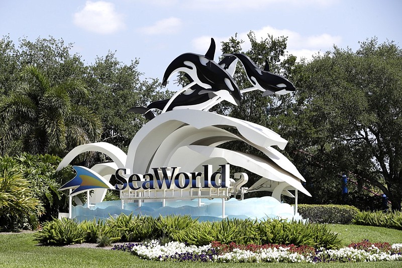 The entrance to the SeaWorld Theme park is seen Monday, March 30, 2020, in Orlando, Fla. SeaWorld is indefinitely furloughing more than 90% of its employees and they won't get paid after March 31. (AP Photo/John Raoux)