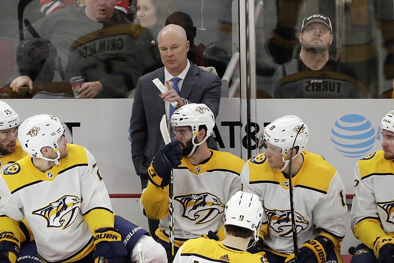 AP photo by Nam Y. Huh / Nashville Predators coach John Hynes, center top, talks to his team during the first period of a game against the host Chicago Blackhawks on Jan. 9.