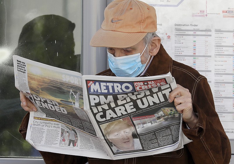 A man reads a newspaper with the headline: 'PM in intensive care', outside St Thomas' Hospital in central London as British Prime Minister Boris Johnson is in intensive care fighting the coronavirus in London, Tuesday, April 7, 2020. Johnson was admitted to St Thomas' hospital in central London on Sunday after his coronavirus symptoms persisted for 10 days. Having been in hospital for tests and observation, his doctors advised that he be admitted to intensive care on Monday evening. The new coronavirus causes mild or moderate symptoms for most people, but for some, especially older adults and people with existing health problems, it can cause more severe illness or death.(AP Photo/Kirsty Wigglesworth)


