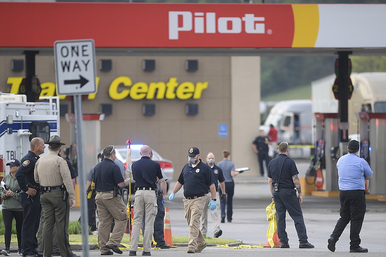 Law enforcement investigates at the scene of a multi-victim stabbing at a Pilot truck stop on Strawberry Plains Pike in Knoxville, Tenn. on Tuesday, April 7, 2020. A man fatally stabbed three employees and wounded a customer at a Tennessee rest stop and travel center Tuesday morning before a deputy shot and killed him, authorities said.(Calvin Mattheis/Knoxville News Sentinel via AP)