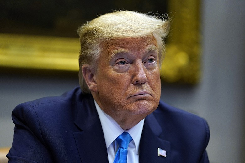 President Donald Trump listens during a conference call with banks on efforts to help small businesses during the coronavirus pandemic, at the White House, Tuesday, April 7, 2020, in Washington. (AP Photo/Evan Vucci)