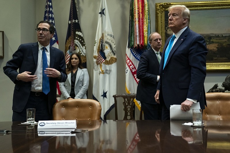 Treasury Secretary Steven Mnuchin and President Donald Trump listen to a question during a conference call with banks on efforts to help small businesses during the coronavirus pandemic, at the White House, Tuesday, April 7, 2020, in Washington. (AP Photo/Evan Vucci)


